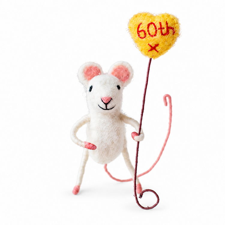 A white felt mouse figurine with pink ears, holding a yellow heart-shaped balloon that reads &